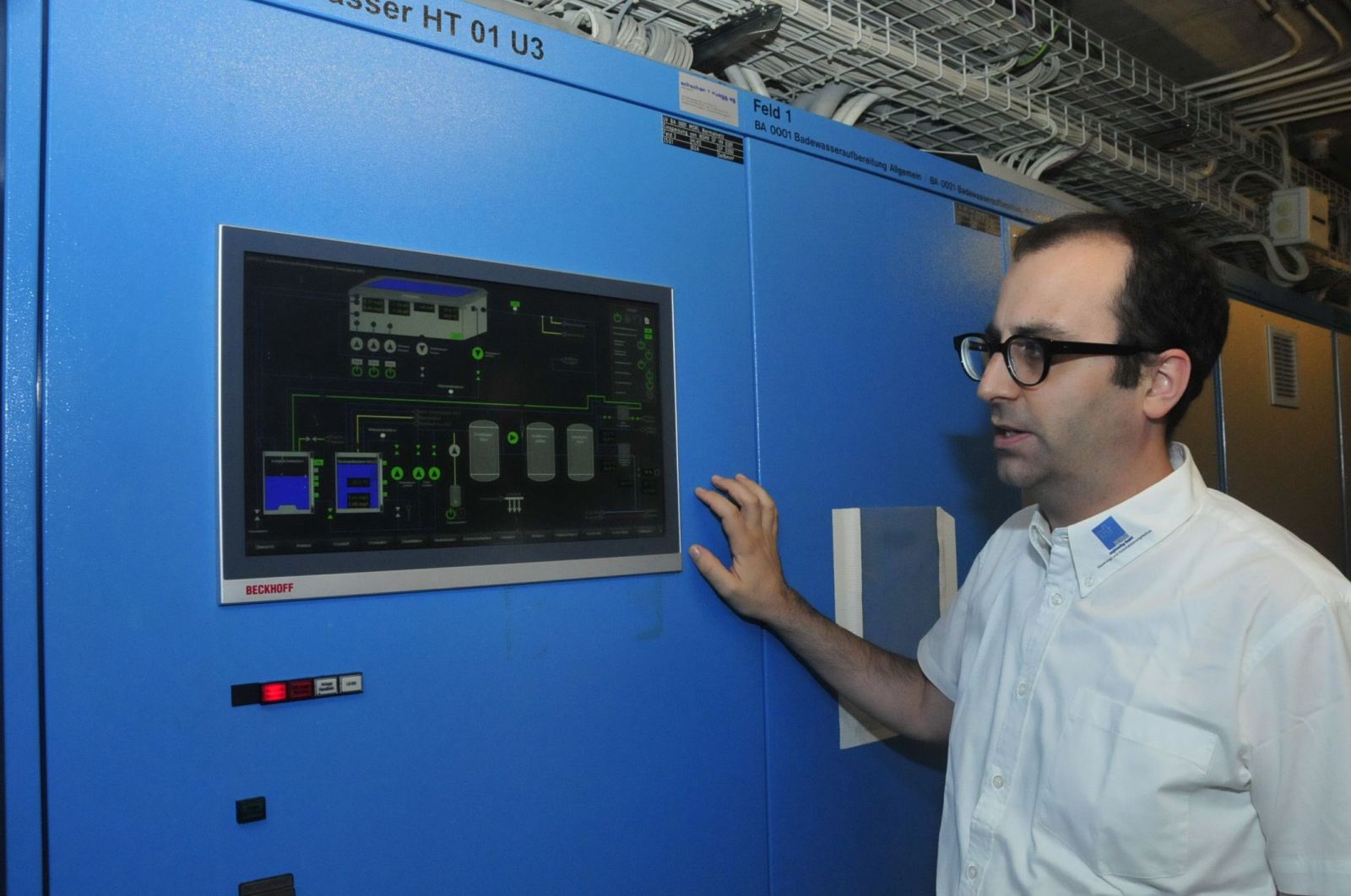 Technician operating the control panel in the hotel plant room